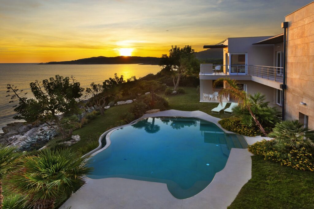 Pool and sea view at sunset in Alghero