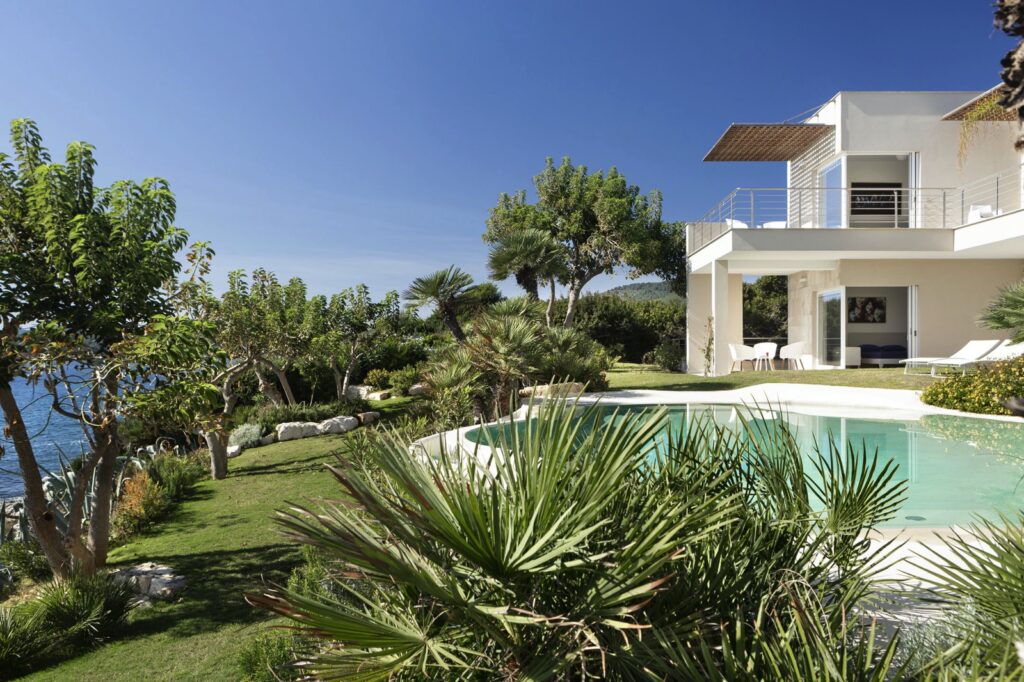 plants in a garden and a swimming pool by the sea