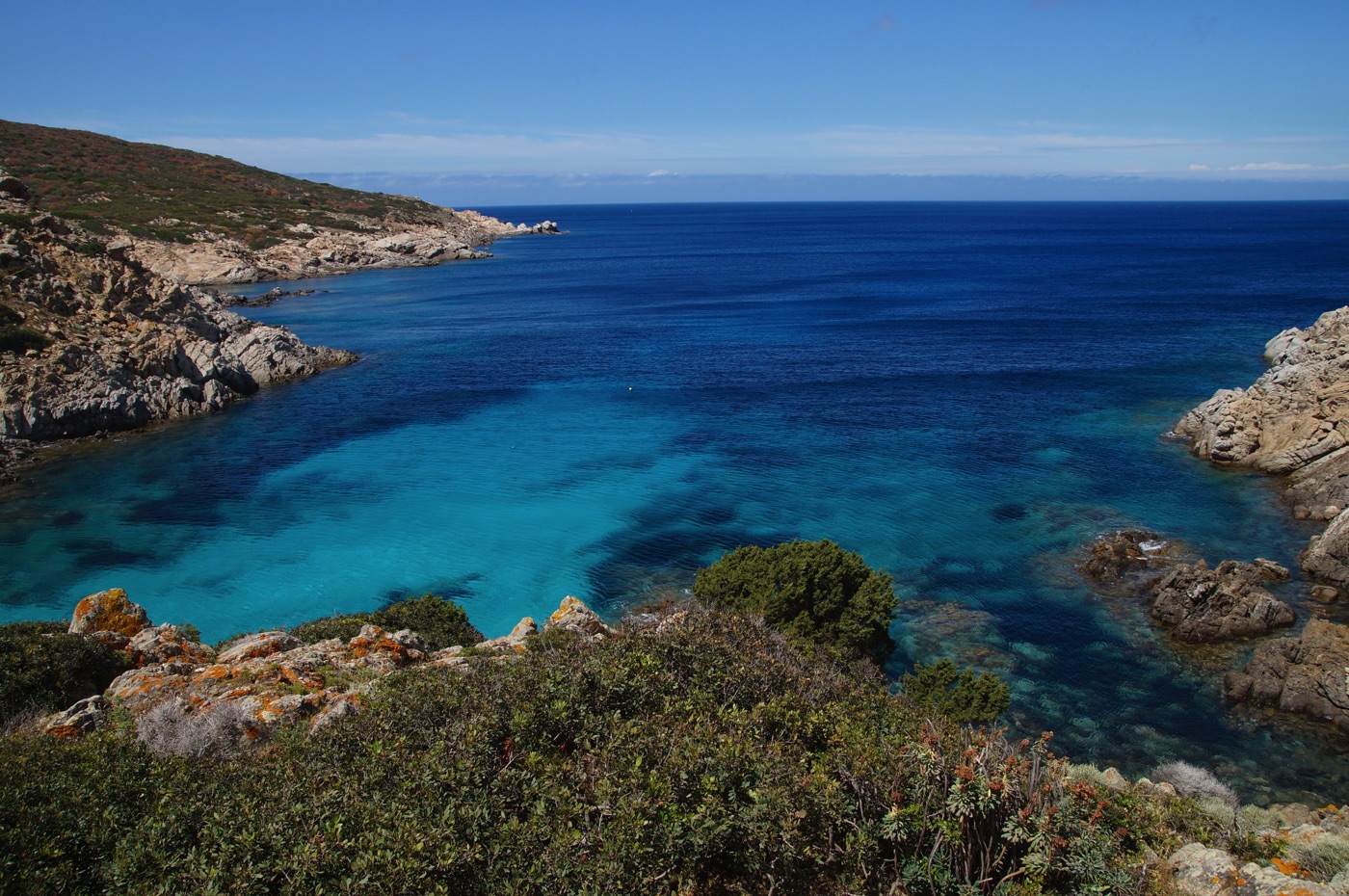 a small cove with crystal clear water in sardinia